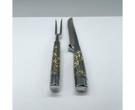 An exquisite pair of brilliant steel knife and fork, adorned with bone-colored handles delicately crafted with intricate stee