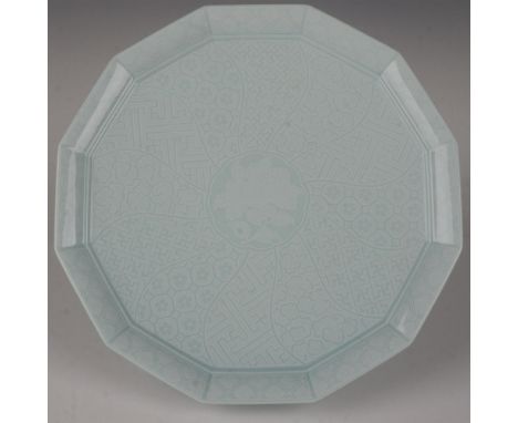 This stunning platter is glazed in a celadon color and decorated with various floral and geometric patterns. This item has it