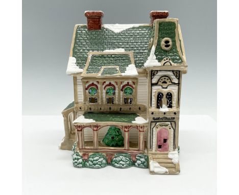 Ceramic hand-decorated farmhouse with porch, open windows, and snow effect. Department 56 backstamp. This item has its origin