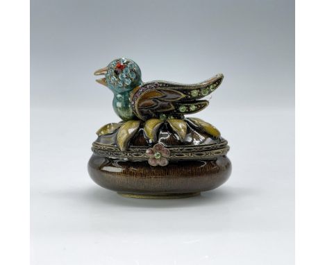 This is a tiny oval box in deeply hued earth tones topped with a crystal encrusted duck. This item has its original box which