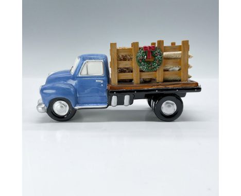 This is a decorative ceramic blue truck with Christmas themed wreaths decorating the rails of the flatbed. Department 56 back