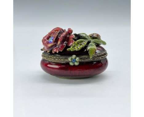 This is a tiny red jewel tone box embellished with a bejeweled rose on top with a crystal encrusted ladybug on the stem. This