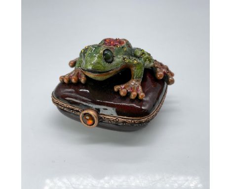This is a playful frog-themed tiny box with a crystal-encrusted tree frog standing on a square pillow-shaped hinged box. This