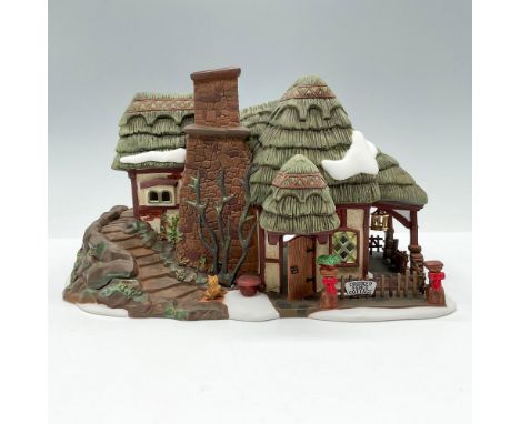 This figure shows a forest village cottage with encompassing staircase and fenced porch. This item has its original box. Dime