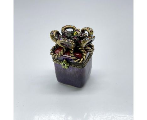 This is a red and purple jewel-toned square box with crystal encrusted bow on top. The interior is a beautiful emerald-green 