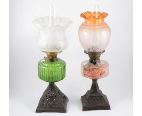 A Victorian oil lamp, acid etched with chimney, acid etched shade, tinted and moulded reservoir, cast iron tapering base, and
