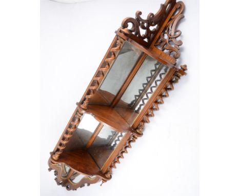 A Victorian mahogany corner shelf, with three shelves joined by barley-twist uprights, shaped mirrored back panels, depth 15c