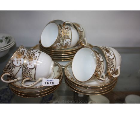 A Noritake Teaset, white ground with gilt decoration comprising eight cups and saucers, six tea plates and bread and butter p