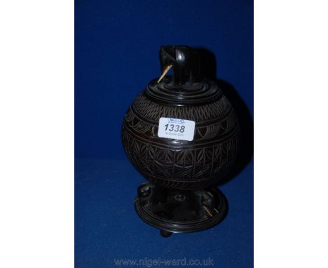 A Tobacco jar made from a Coconut shell with carved decoration and Elephant finial to the lid.