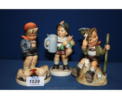 Three Goebel ''Hummel'' figures including a boy with Edelweiss, 'Farm Boy' and 'Tankard and Turnip'.