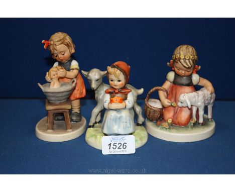 Three Goebel ''Hummel'' figures including 'Doll Bath', 'Favourite Pet' and 'Good Friends'.