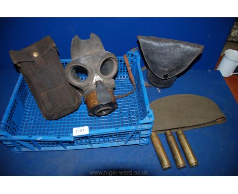 A quantity of WWII items including gas masks, ammunition pouch, army side cap and three 20mm. 1942 Brass Shells