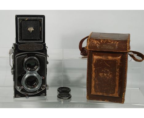 A Minolta Autocord Twin Lens Reflex Camera with a Chiyoko Rokkor 75mm f/3.5 Lens, lens cap and original case.