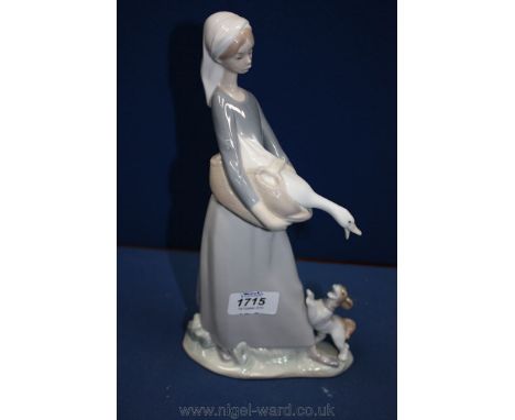 A Lladro figure of a girl with a goose and puppy, no. 4866, 11'' tall.
