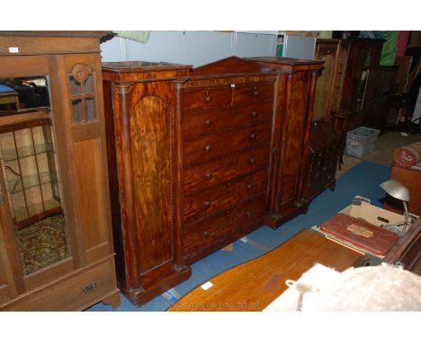 A Victorian Mahogany Tall Chest flanked by single door Wardrobes, architectural in design having shallow triangular pediment 