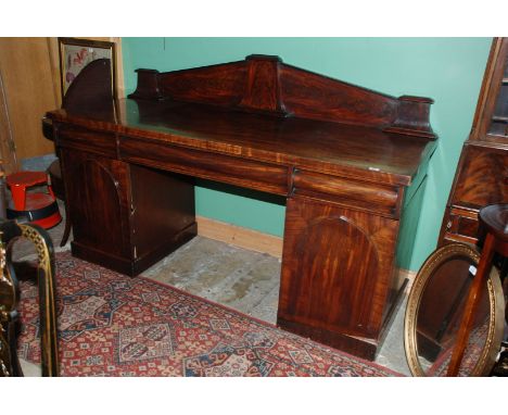 A good Victorian Mahogany Sideboard having architectural upstand back with three capped stylised trapezoid shaped columns ove