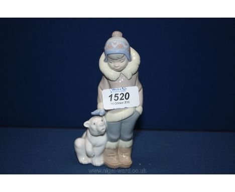 A Lladro figure of a boy with a Polar Bear cub, 5'' tall.