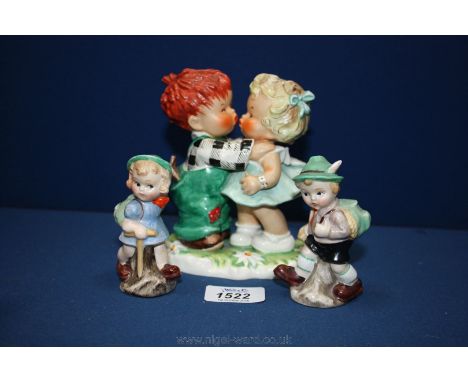 An early Goebel figure of a girl and boy kissing (Stolen Kiss), base repaired, and a pair of Goebel girl and boy salt and pep