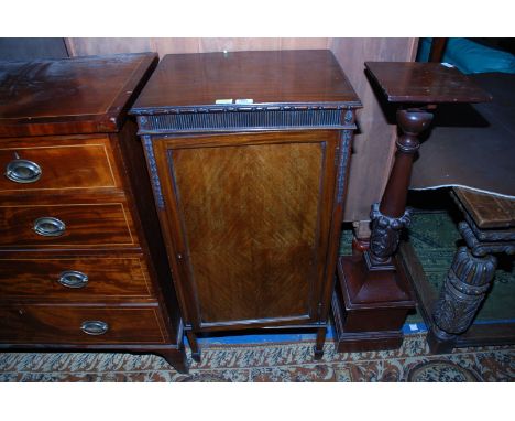 An Edwardian Mahogany Cabinet, having moulded edge rectangular top over reeded frieze, over single panel 1/4 veneered door op