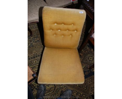 A late 19th c. upholstered button-back Nursing Chair in gold velvet draylon fabric, standing on turned front legs.