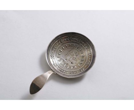 A GEORGE III CADDY SPOON with a circular bowl, stamped in the centre with a Chinaman within decorative concentric borders, ma