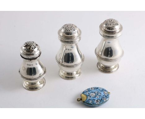 A PAIR OF EARLY 20TH CENTURY BALUSTER PEPPERETTES with bun covers, by J.B. Carrington &amp; Co., London 1936, another smaller