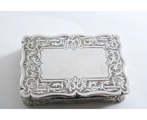 A VICTORIAN ENGRAVED SNUFF BOX with a serpentine outline, concaved sides and a vacant cartouche on the cover, by Frederick Ma