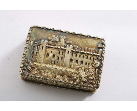 AN EARLY VICTORIAN SILVERGILT "CASTLETOP" VINAIGRETTE with rectangular chased sides and an engine-turned base, with a view of