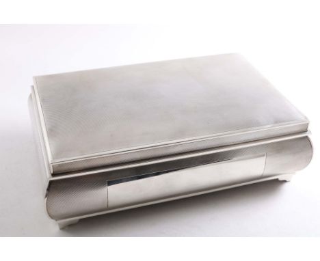 AN EARLY 20TH CENTURY ENGINE-TURNED CIGARETTE BOX with small bracket feet, a low domed cover and convex sides, the front with