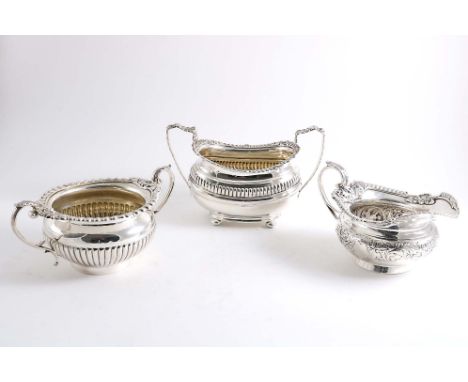 A LATE VICTORIAN DECORATIVE CREAM JUG squat circular form on a collet foot, by L.A. West &amp; Son (of Dublin), hallmarked Lo