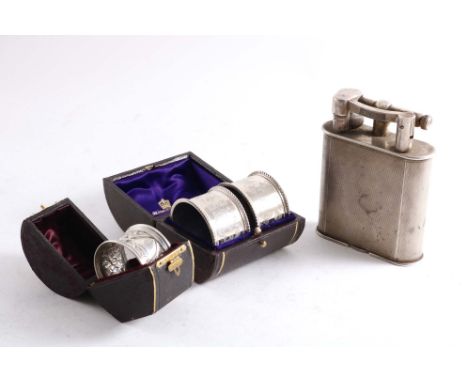 AN EARLY 20TH CENTURY ELECTROPLATED DUNHILL TABLE LIGHTER with an engine-turned rounded oblong body, c.1930 together with a l