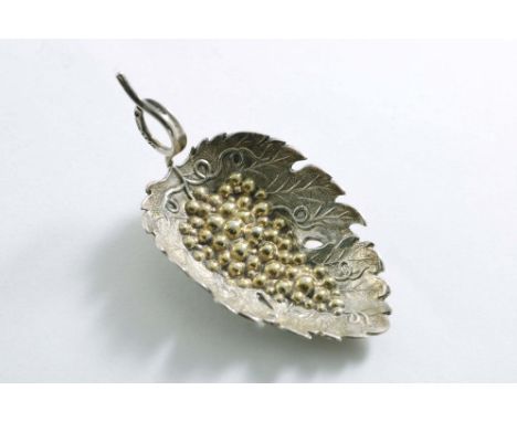 A GEORGE III PARCELGILT CADDY SPOON with a vine leaf bowl with grapes in relief and a coiled tendril handle, by Joseph Wilmor