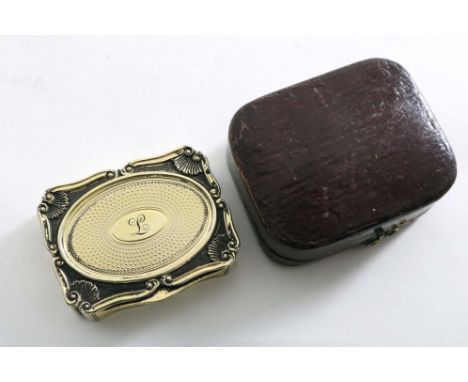 A GEORGE IV SILVERGILT VINAIGRETTE with a rectangular serpentine outline and engine-turning, the cover with an oval reserve b