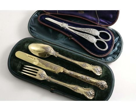 A VICTORIAN CASED PARCELGILT CHRISTENING KNIFE, FORK &amp; SPOON Bright Vine pattern, by George Adams, London 1860/65 and a c