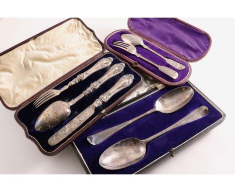 THREE CASED SETS:- A Victorian engraved Christening knife, fork &amp; spoon with ornate handles (loaded), maker's mark "B&amp