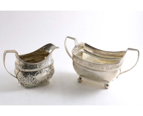 A GEORGE III IRISH BOAT-SHAPED SUGAR BASIN on ball feet, with an engraved frieze below the rim and reeded border &amp; handle