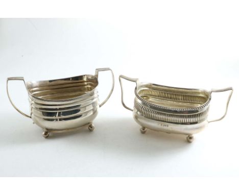 A GEORGE III BARGE-SHAPED SUGAR BASIN on ball feet with twin handles and a reeded rim, by William Hall or Hunter, London 1810