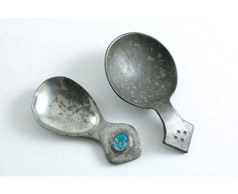 AN EARLY 20TH CENTURY PEWTER CADDY SPOON with an enamelled boss, by Liberty &amp; Co., and a larger pewter caddy spoon with a