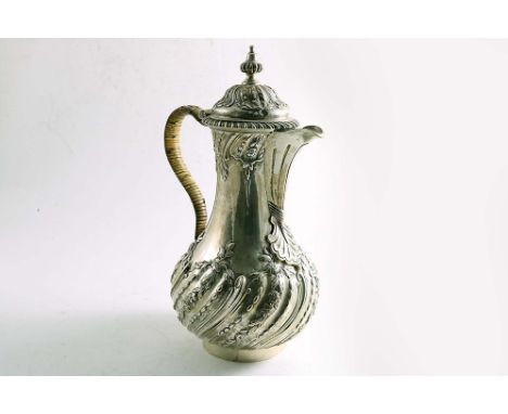 AN EARLY GEORGE III BALUSTER HOT WATER JUG with domed cover, fluted knop finial and a cane-insulated, scroll handle, the uppe