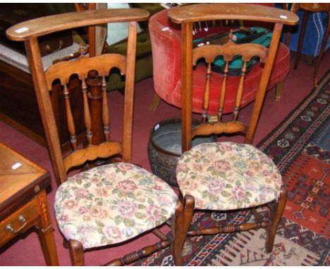 A pair of stained beech prie-dieu chairs with tapestry overstuffed padded seats