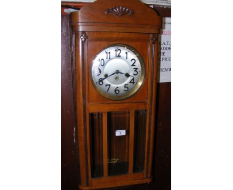 A 1930's oak cased chiming wall clock