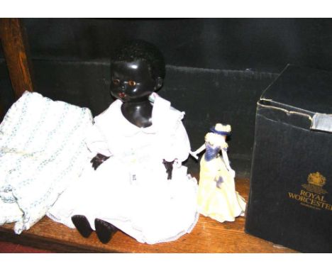 A Pedigree composition black doll with sleepy eyes and a Royal Worcester figurine "Alice"