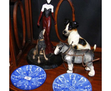 A pair of Japanese blue and white plates, Art Deco style figure with dog and two ceramic animals