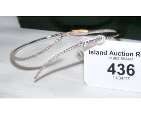 An 18ct white gold diamond bangle