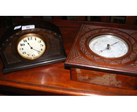 A table top aneroid barometer and an oak cased mantel clock timepiece