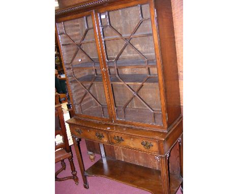 A mahogany Chippendale style bookcase on stand, having two drawers to the front