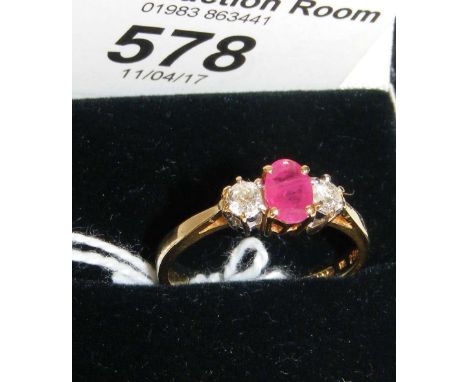 An 18ct gold ruby and diamond three stone ring