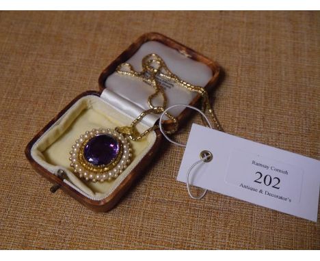 Mid-19th century gold, amethyst and seed pearl brooch/pendant, the large oval-cut amethyst within a band of seed pearls, moun