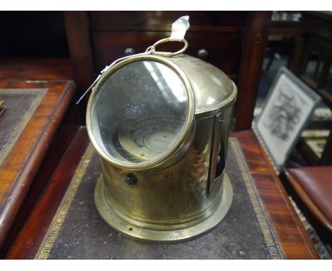 Brass lifeboat compass, early 20th century, contained in a brass binnacle with ring carrying handle. Height inc. handle 27cm
