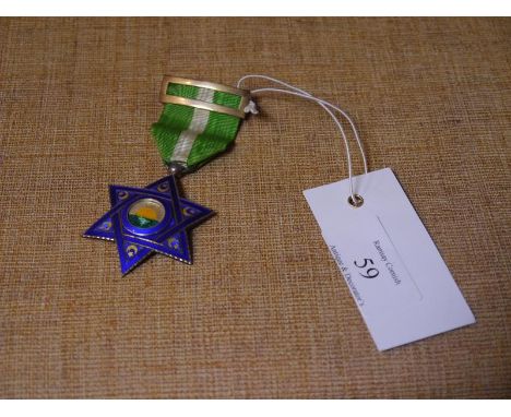 Diplomatic Order , a blue enamel star centred by a rising sun, the terminals decorated with crescent moon and star, on a gree